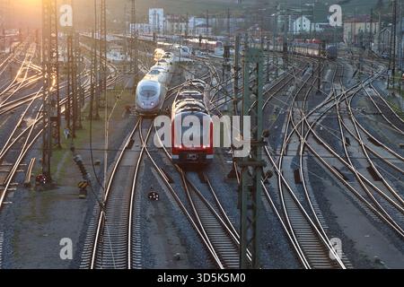 German railway junction with ICE and regional train at sunset - Würzburg- Germany Stock Photo