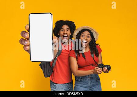 Happy Couple Cheerful While Taking Selfies With Smartphone in Bright Studio Setting Stock Photo