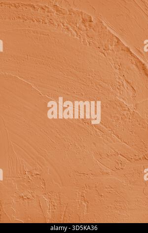 Close up, macro of vibrant orange colored cement wall surface with rough, heavily textured, and abstract plaster strokes. Grunge background, industria Stock Photo