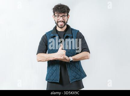 Person gesturing help with hands in nonverbal language. Smiling man showing help gesture with hands in sign language Stock Photo
