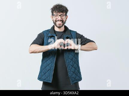 Funny man making heart shape isolated. Handsome guy making heart shape with hands Stock Photo