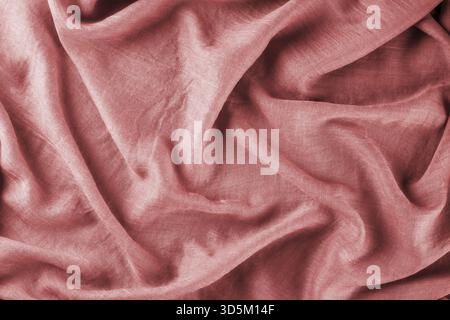 Close-up of bright pink draped lightweight fabric as background. Selective focus Stock Photo