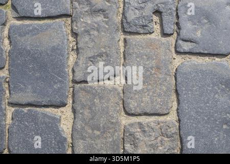 Fragment of a old cobblestone pavement. Horizontal orientation, selective focus Stock Photo