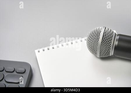Podcast concept. Black microphone, content notebook. Close up. Audio music device. Recording production. School knowledge equipment. Home online teach Stock Photo