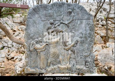Station XIII: Jesus is taken down from the Cross. The Way of the Cross on Mount Križevac (the Cross Mountain) in Medjugorje. Stock Photo
