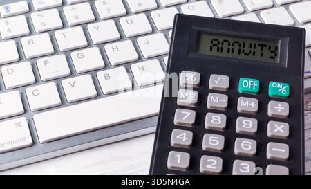 Calculator Displaying the Word "Annuity" on a Keyboard, Symbolizing Financial Planning, Retirement Savings, and Investment Calculation Stock Photo