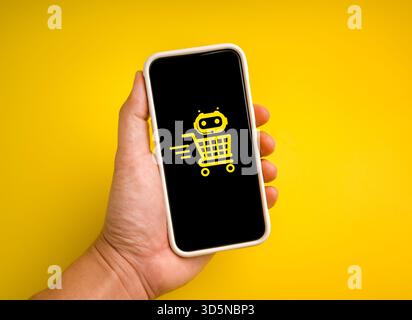 Hand holding smartphone with AI shopping assistant icon. Concept of artificial intelligence in e-commerce, smart retail, automated online shopping, pe Stock Photo