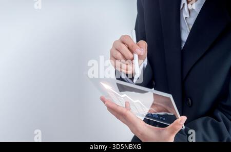 Businessman or trader analyzing financial growth data graph on futuristic digital tablet with copy space. Concept of investment, finance technology, s Stock Photo