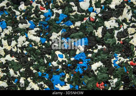 A detailed macro view of the textured surface of an archery backstop constructed from compressed colored foam fragments designed to safely absorb arro Stock Photo