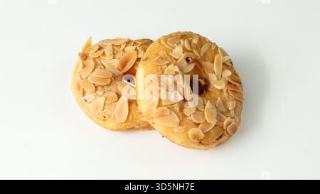 two donuts with almond topping on a white background Stock Photo