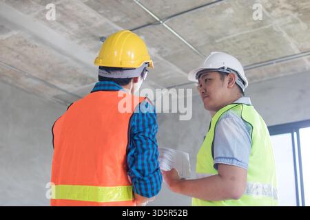 engineer with worker check and work in building Stock Photo