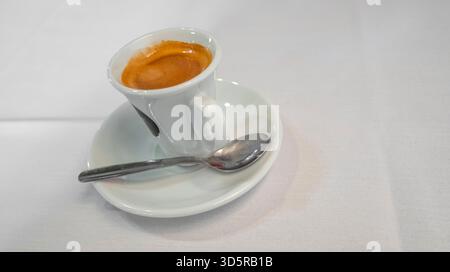 Coffee Cup with Saucer and Spoon on a White Background Stock Photo