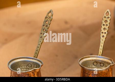 Copper hand-operated coffee pots, called Turks, at a Turkish bazaar for making coffee on sand. Stock Photo