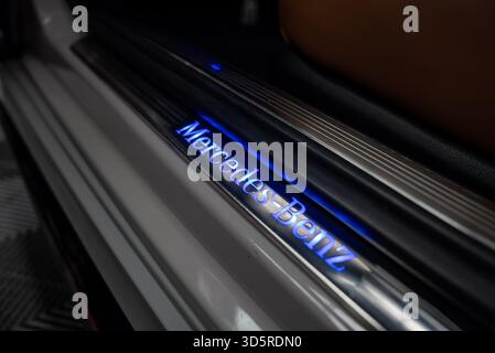Illuminated Mercedes Benz door sill in workshop with moody lighting Stock Photo
