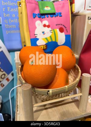 Bukit Bintang, Kuala Lumpur, Malaysia - Nov 17, 2025 : Miniature Oranges in Bamboo Basket Display Stock Photo
