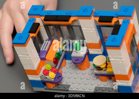 Children are engaged in imaginative building using colorful blocks indoors. Stock Photo