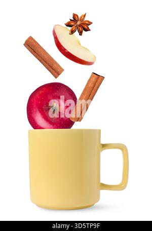 Health boosting drink for cold season. Apples, cinnamon and anise falling into cup on white background Stock Photo