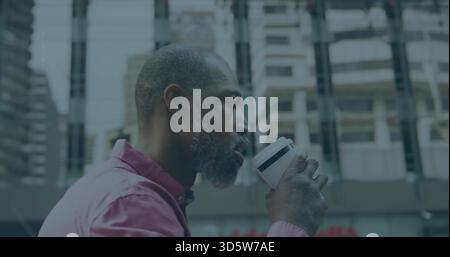 Drinking mature man holding white travel coffee cup on city plaza, pink shirt, copy space Stock Photo