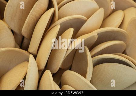 A close arrangement of wooden spoons showcases their smooth surfaces and rounded edges, highlighting their craftsmanship and natural wood tones in a w Stock Photo