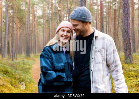 happy couple in love walking at autumn forest on romantic date Stock Photo