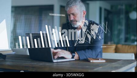 Analyzing senior man wearing blazer, watch, working on laptop with digital charts and phone at home Stock Photo