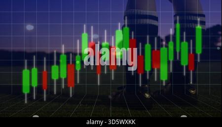 Displaying candlestick chart overlay covering turf at dusk, showing grid green red bars and cleats Stock Photo
