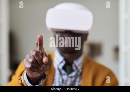 Mature Black Man Using Virtual Reality Headset and Interacting Digitally Stock Photo