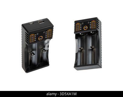 Two black universal two-slot battery chargers with display indicators and USB ports, isolated white. Stock Photo