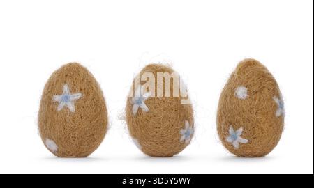 Three easter eggs decorated with small white and light blue flowers. Standing, isolated on a white background, Netherlands Stock Photo