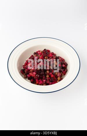 Vinaigrette salad with beetroot, potato, carrot and peas, diced and dressed, isolated on white Stock Photo
