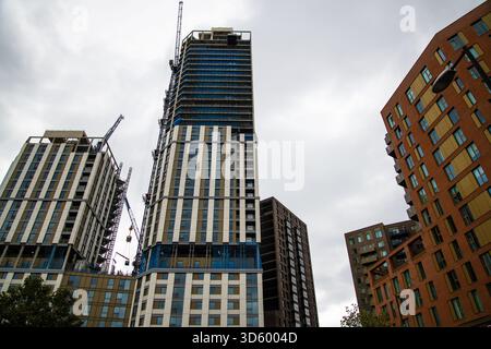 Ground-level view of new high-rise buildings under construction at the Heart of Hale development near Tottenham Hale station in London, showing cranes Stock Photo