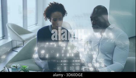 Colleagues working on laptop in lounge, woman dark sweater, man white shirt, viewing binary overlay Stock Photo