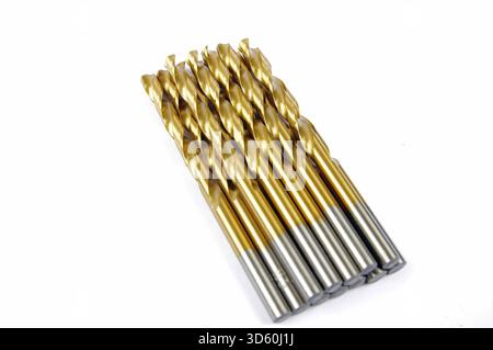 a row of gold metal drill bits on a white background Stock Photo