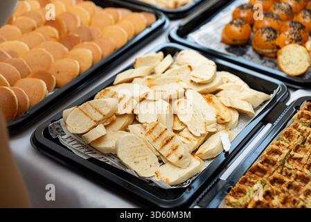 Moscow, Russia - October 09, 2025 - A variety of breads and pastries beautifully arranged on trays. the display includes sliced breads, soft rolls, an Stock Photo