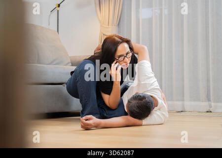 Senior man suffering heart attack and wife trying to save life of friend or husband with calling emergency. Heart attack concept. Stock Photo