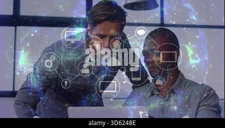 Collaborating two men in button shirts and blazer viewing laptop screen at office, digital overlay Stock Photo