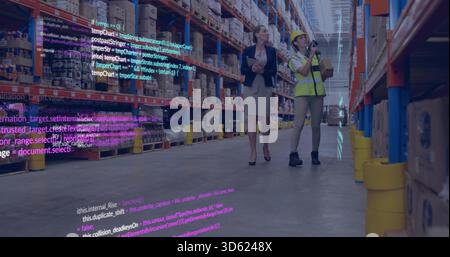 Inspecting manager in blazer and worker in hi-vis vest scanning shelves in warehouse, with scanner Stock Photo
