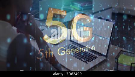 Showing silver laptop displaying data on wooden desk at home, featuring 5G glyphs, smartphone Stock Photo