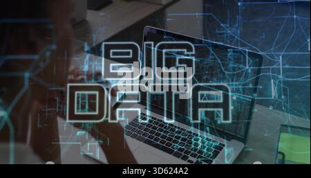 Showing laptop screen running code and data at desk, with smartphone, notepad, BIG DATA overlay Stock Photo