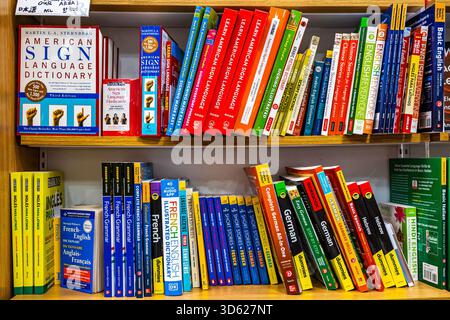 Bookshelf of language learning books including American Sign Language, French, German, and Hebrew, bookstore with a shelf about foreign languages Stock Photo