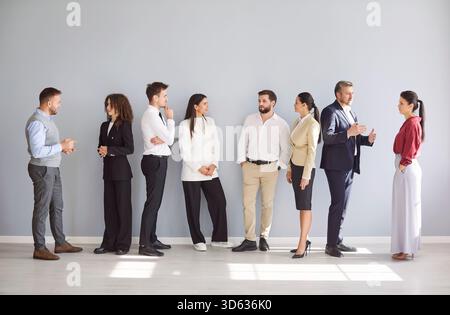 Professionals Engaging in Conversation in a Modern Office Setting During Daylight Hours Stock Photo