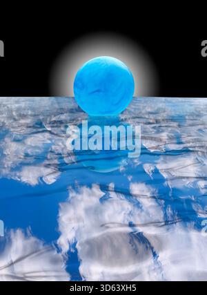 Blue ball floating on water with clouds reflecting Stock Photo