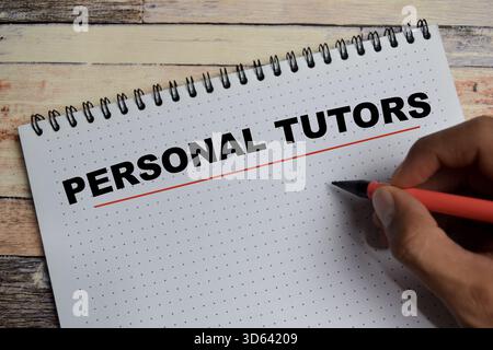Concept of personal tutors write on book isolated on Wooden Table. for digital learning assistant an AI education tools Stock Photo
