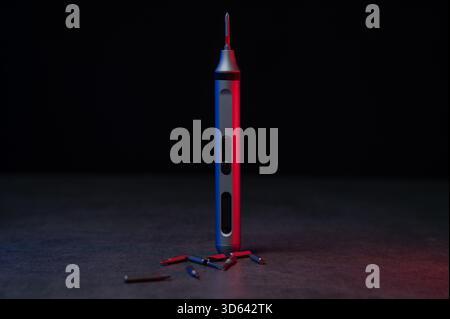 Electric mini screwdriver and several different interchangeable bits. Stock Photo