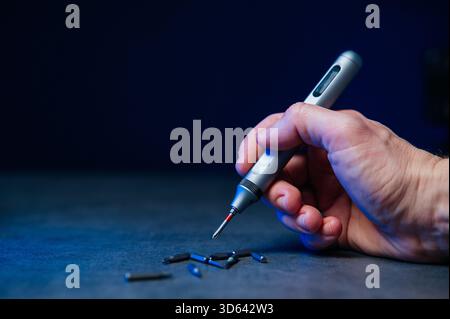 Electric mini screwdriver and several different interchangeable bits. Stock Photo