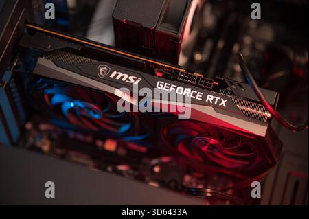 MSI Geforce RTX graphics card, Installing video card in an open case of PC. Hardware components for build PC or mining rig Stock Photo