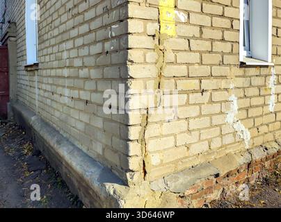 Vertical crack in the wall at the corner of a brick house Stock Photo