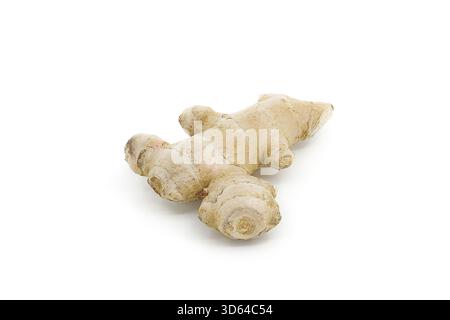 Raw ginger root displayed on white background, emphasizing its organic form and textured surface. Stock Photo