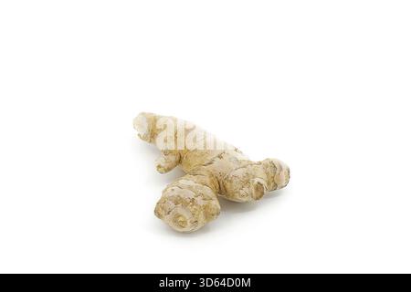 Fresh ginger root isolated on bright white, displaying rough textures, layered skin, and natural shape under soft lighting. Stock Photo
