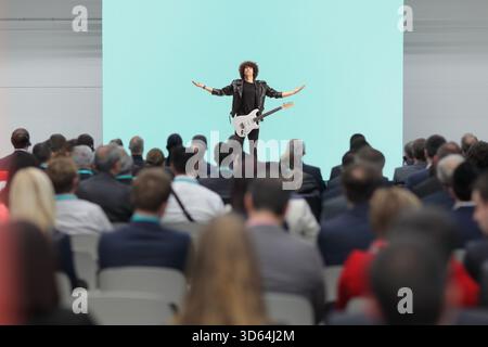 Man with electric guitar performing on stage Stock Photo